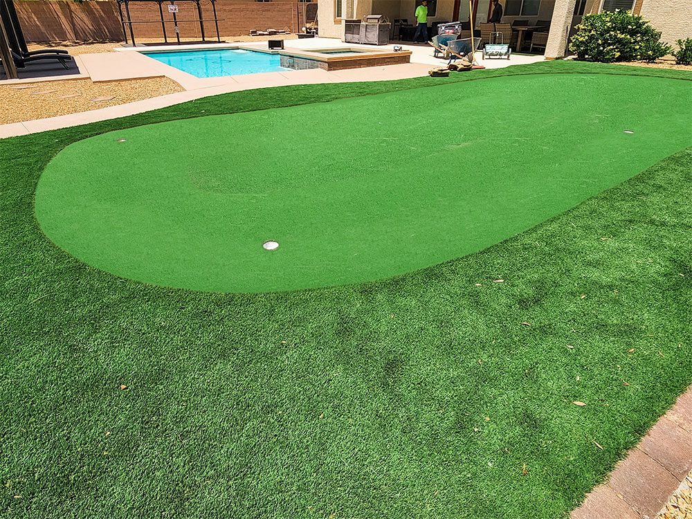 Putting green turf being installed