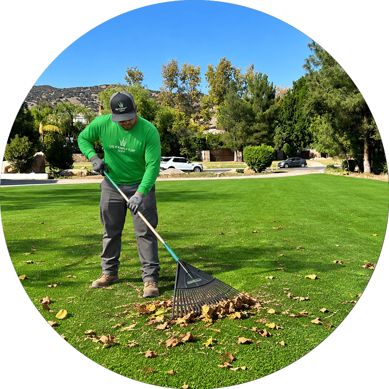 US Family Turf technician removing leaves and debris from artificial turf